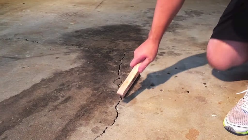 Clean cracks garage floor before paint